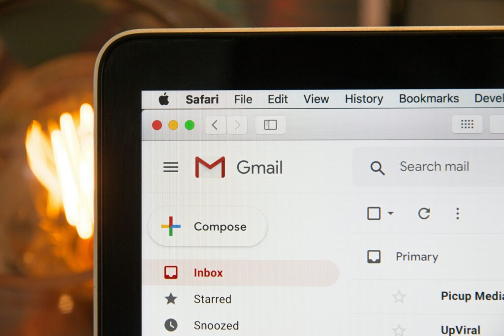 An open laptop showing a Gmail inbox on the screen