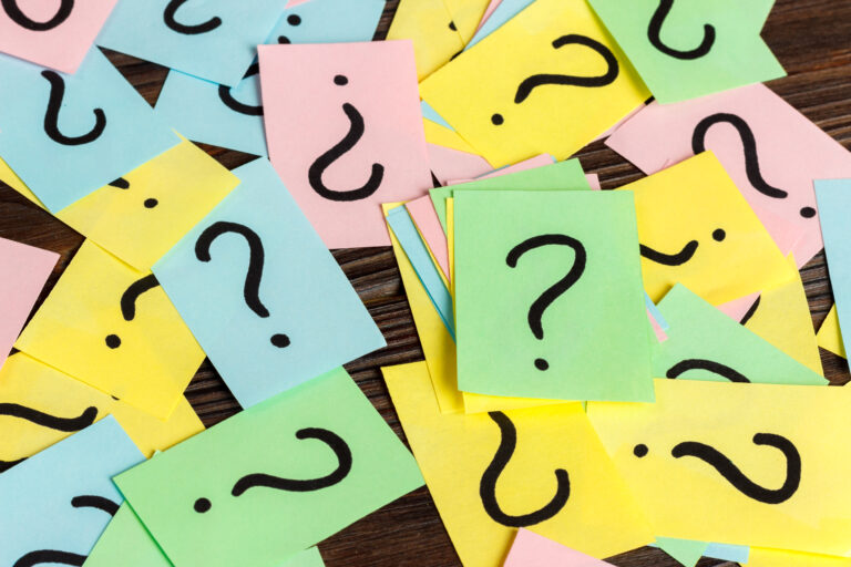 Pile of colorful paper notes with question marks